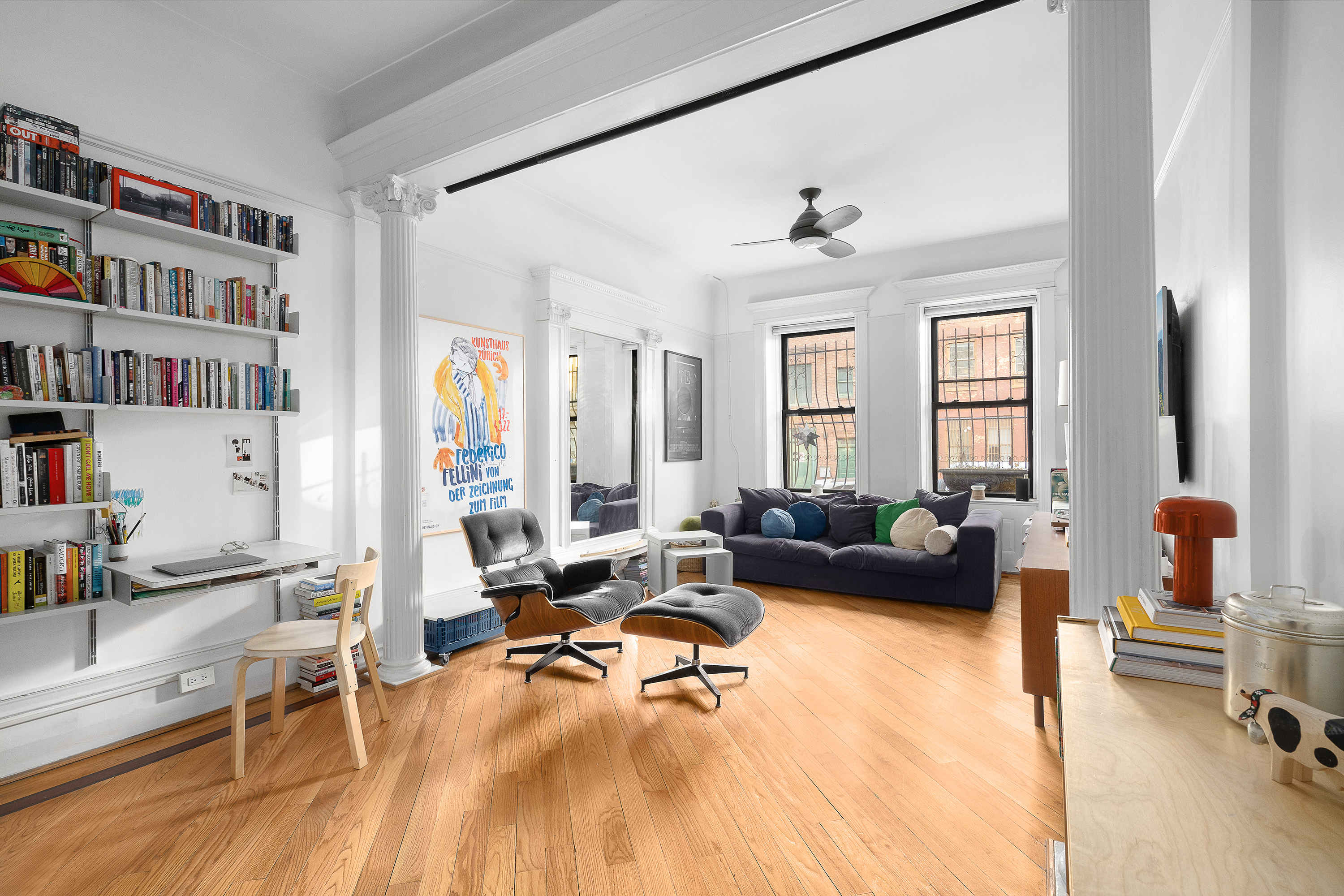 a living room with furniture and a book shelf