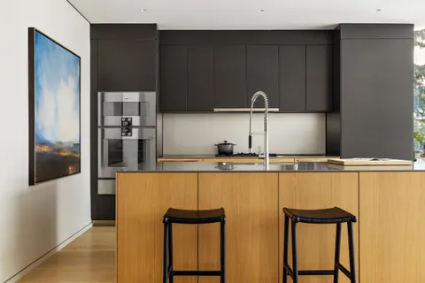 a kitchen with a refrigerator and cabinets