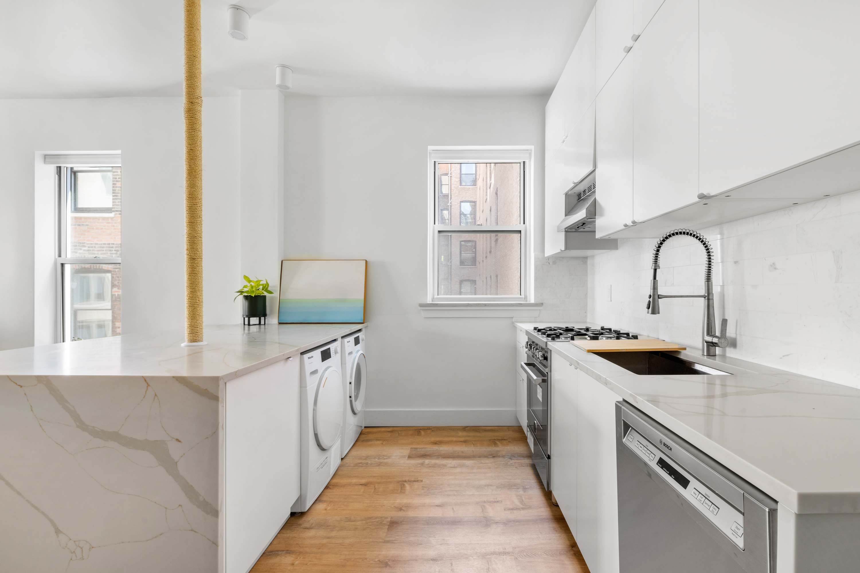 345 West 70th Street, Unit 5F Manhattan, NY 10023 - Photo 4 of 13 a kitchen with granite countertop a sink stove and cabinets