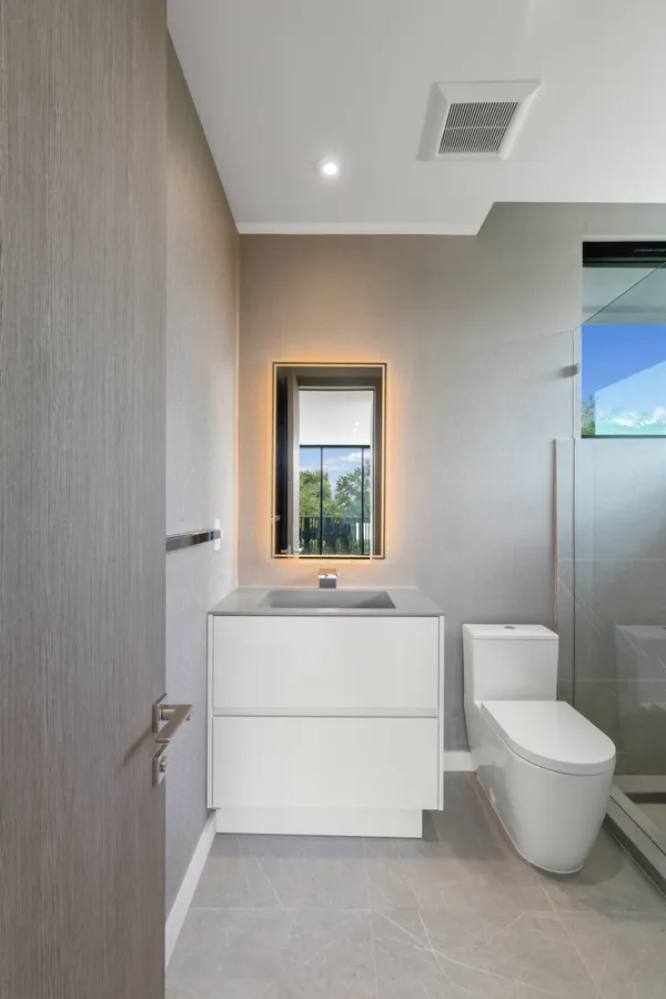 a bathroom with a white tub shower and sink