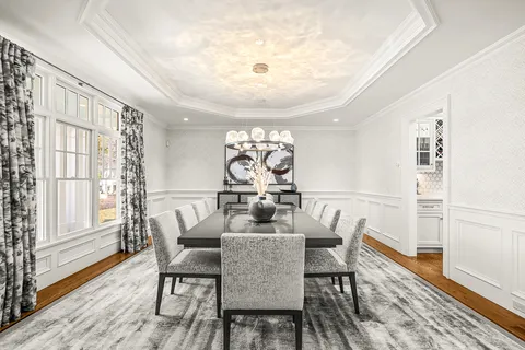 a dining room with furniture a rug and wooden floor