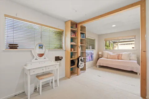 a bedroom with furniture and a large window