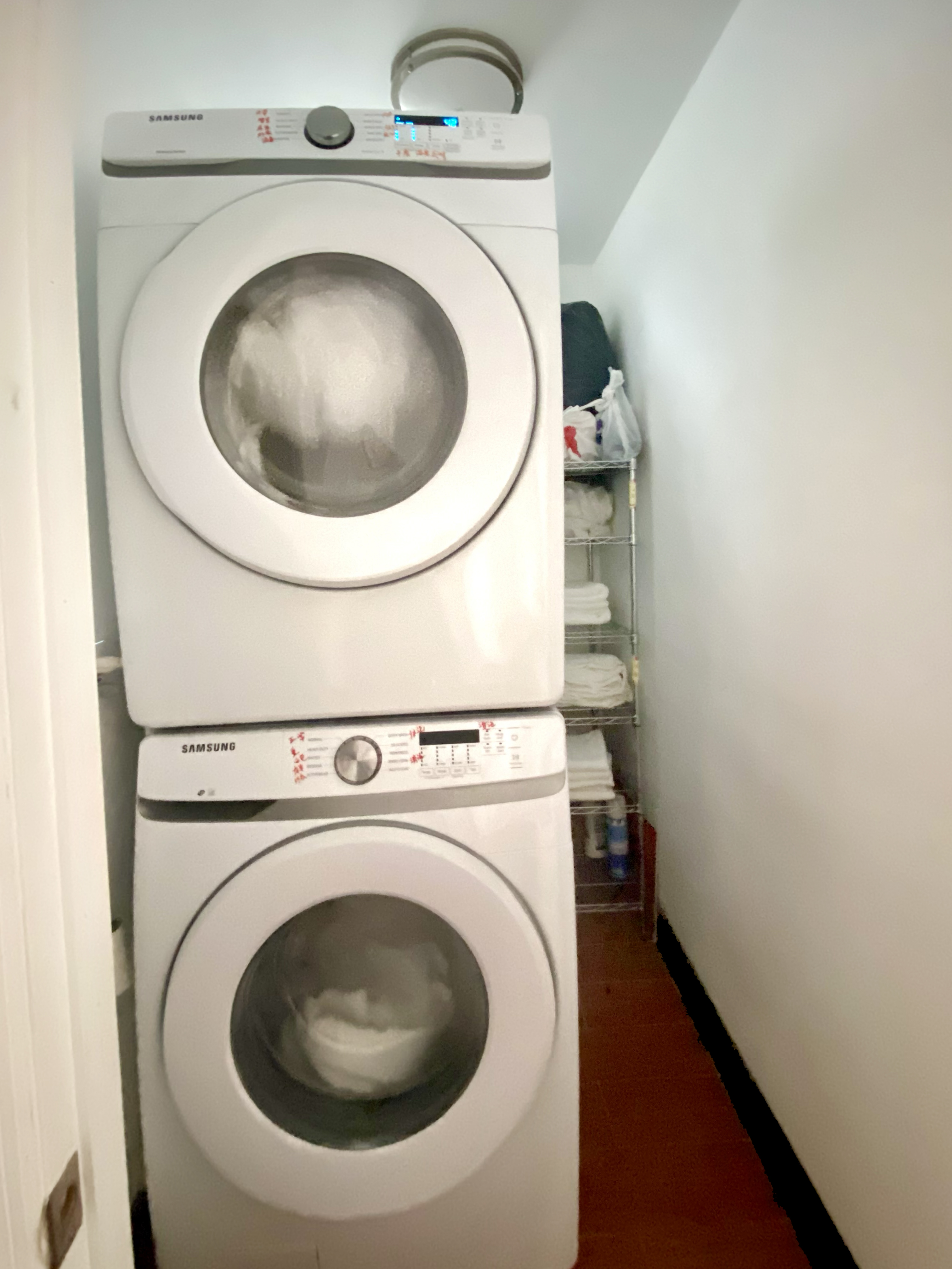 40 East Broadway, Unit 5 Manhattan, NY 10002 - Photo 9 of 10 a utility room with dryer and washer