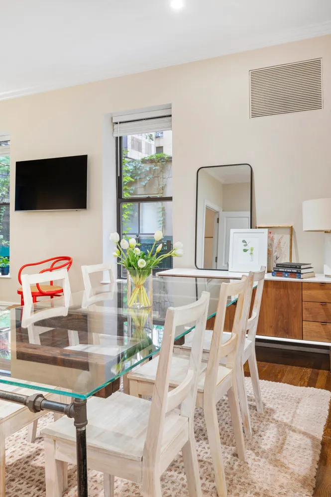 a dining room with furniture and window