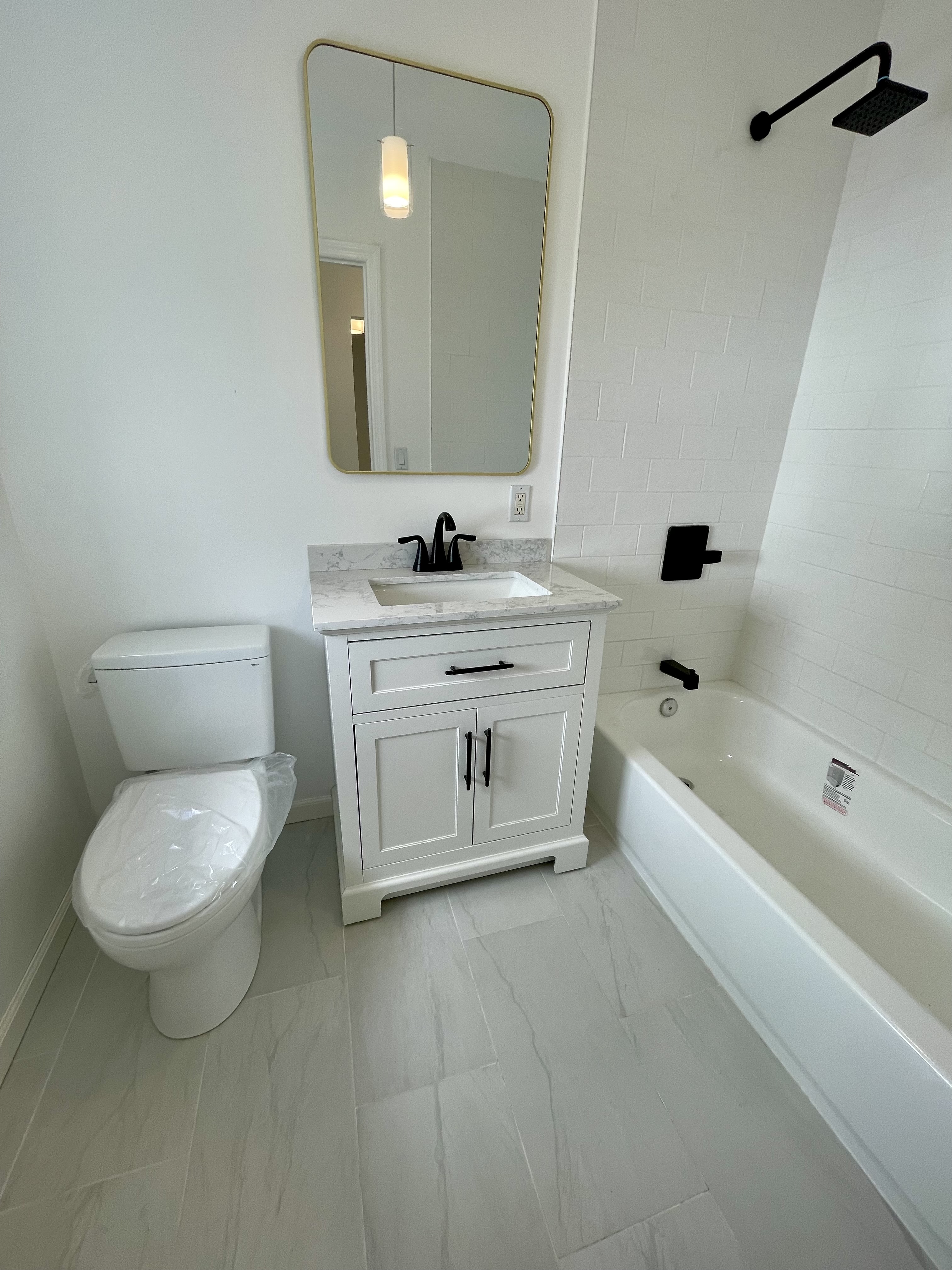 3194 Webster Avenue Bronx, NY 10467 - Photo 10 of 23 a spacious bathroom with a granite countertop toilet a sink and a bathtub