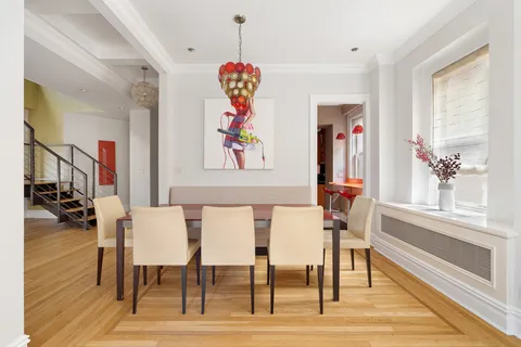 a view of a dining room with furniture a chandelier and wooden floor