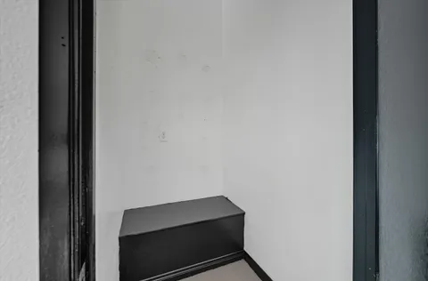 a dining room with furniture and a potted plant