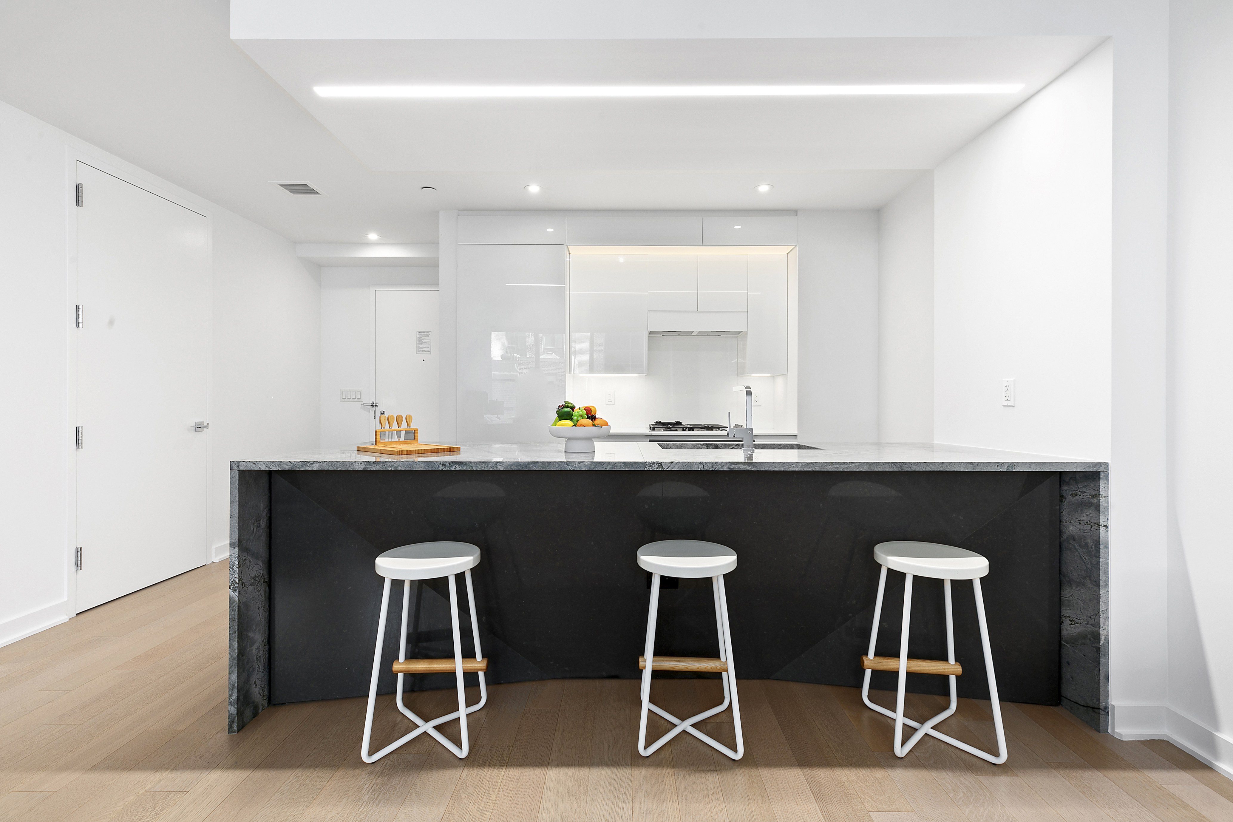 400 Park Avenue South, Unit 23G Manhattan, NY 10016 - Photo 4 of 7 a kitchen with a sink cabinets and dining table