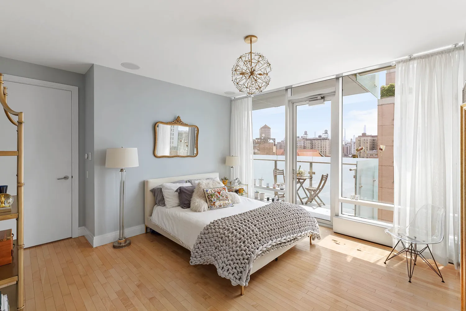 a bedroom with a bed and a large window