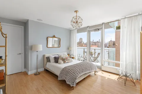 a bedroom with a bed and a large window