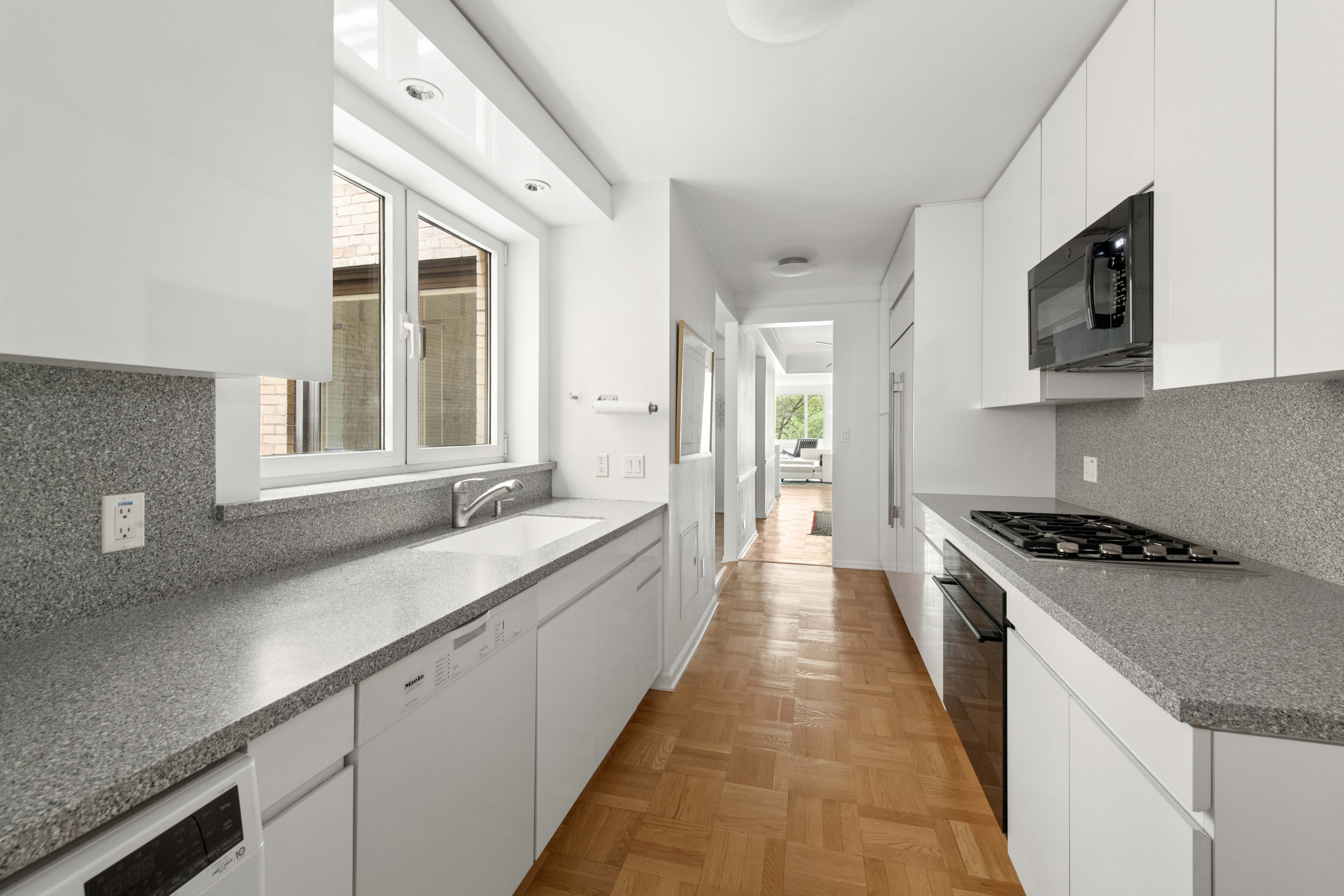 860 5th Avenue, Unit 3H Manhattan, NY 10065 - Photo 4 of 17 a large kitchen with stainless steel appliances granite countertop a lot of counter space and a sink