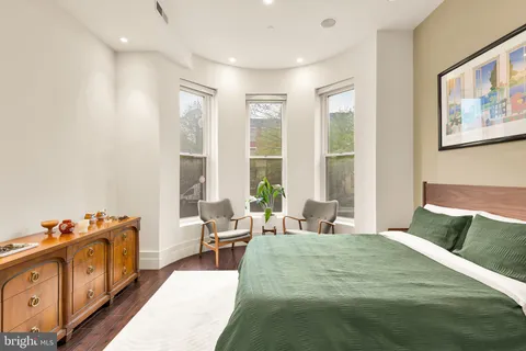 a bedroom with a bed and glass windows