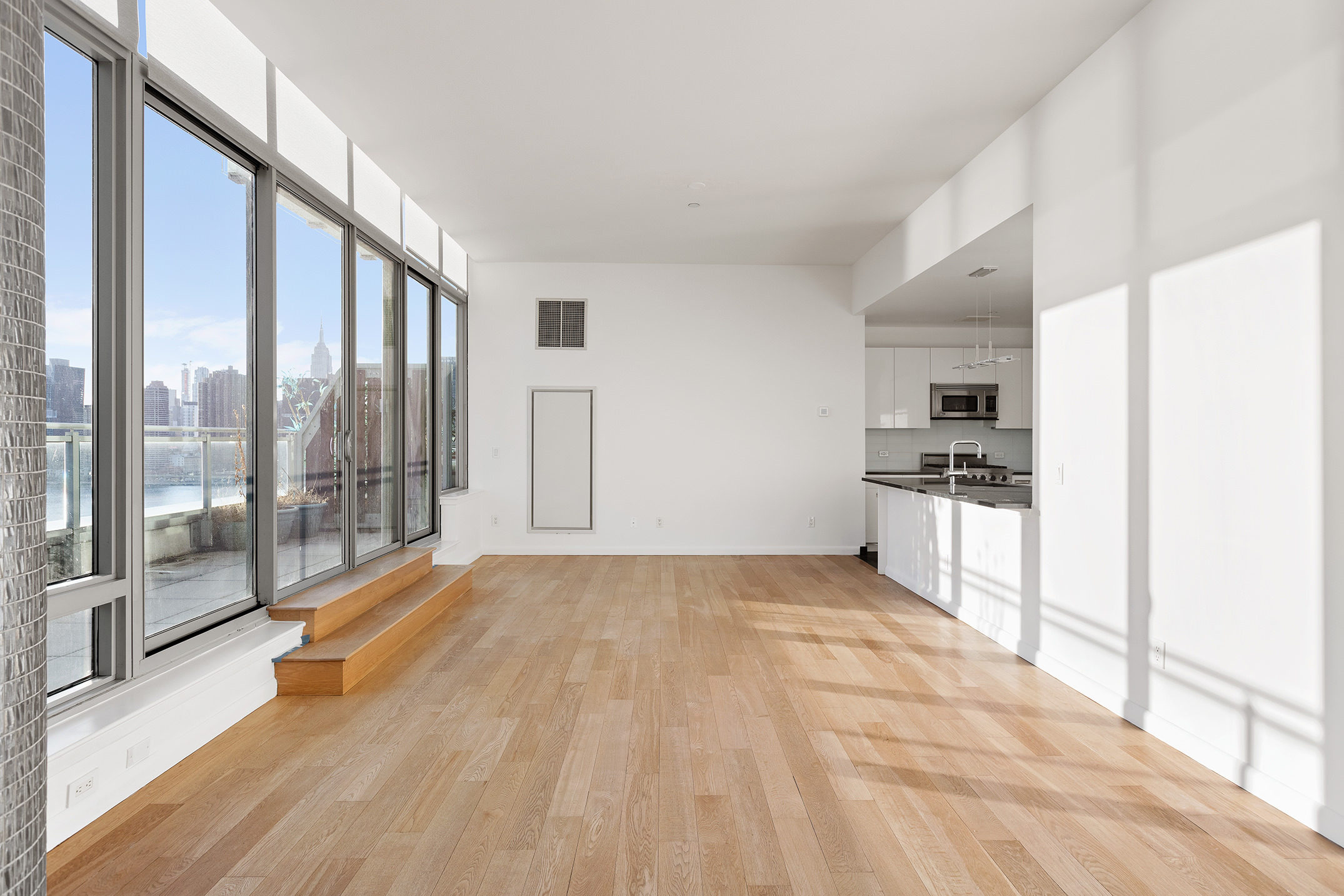46-30 Center Boulevard, Unit PH8 Queens, NY 11109 - Photo 4 of 32 a big room with wooden floor and windows