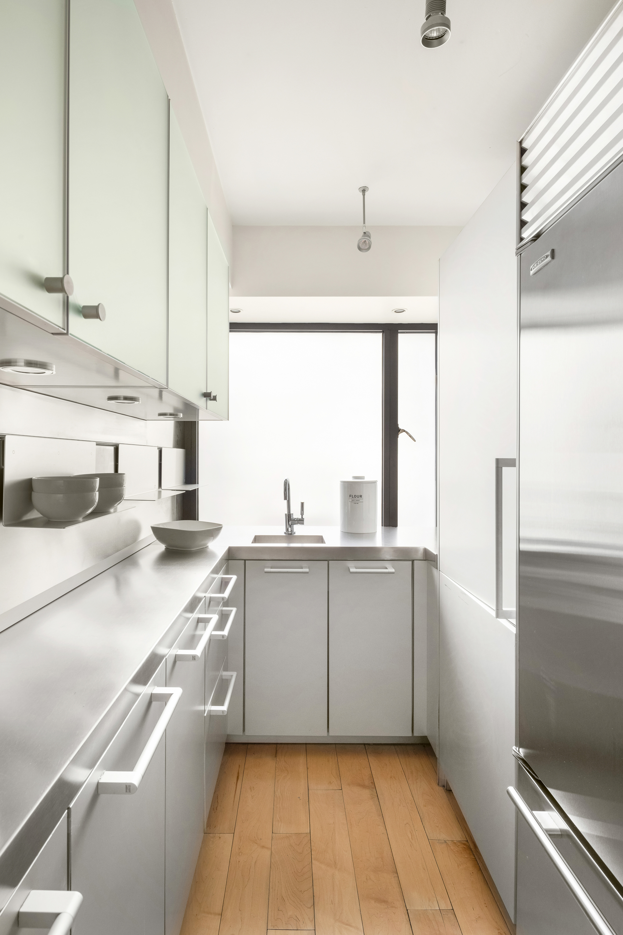 510 East 86th Street, Unit 17C Manhattan, NY 10028 - Photo 15 of 31 a kitchen with stainless steel appliances a sink and a stove