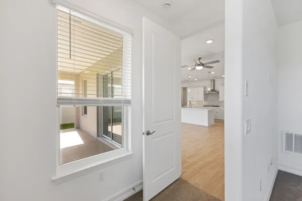 an empty room with windows and entrance