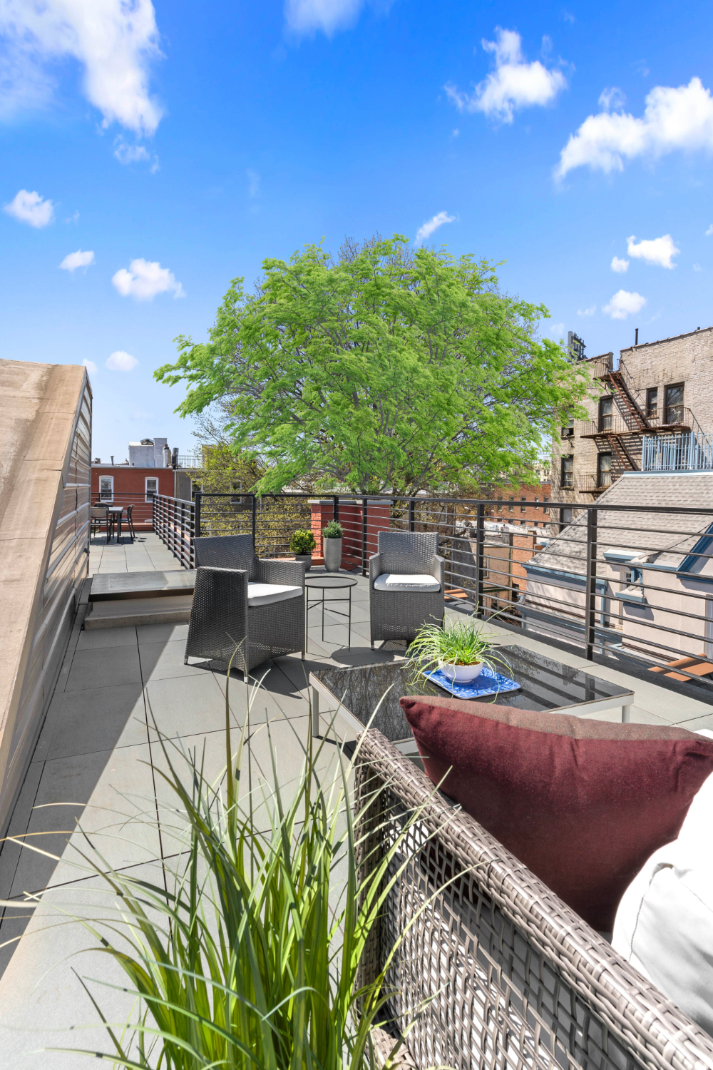 1370 Dean Street, Unit PHD Brooklyn, NY 11216 - Photo 9 of 12 a view of a patio with couches table and chairs and potted plants