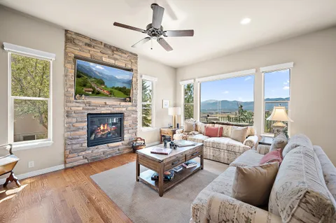 a kitchen with stainless steel appliances granite countertop a sink a stove and a wooden floors