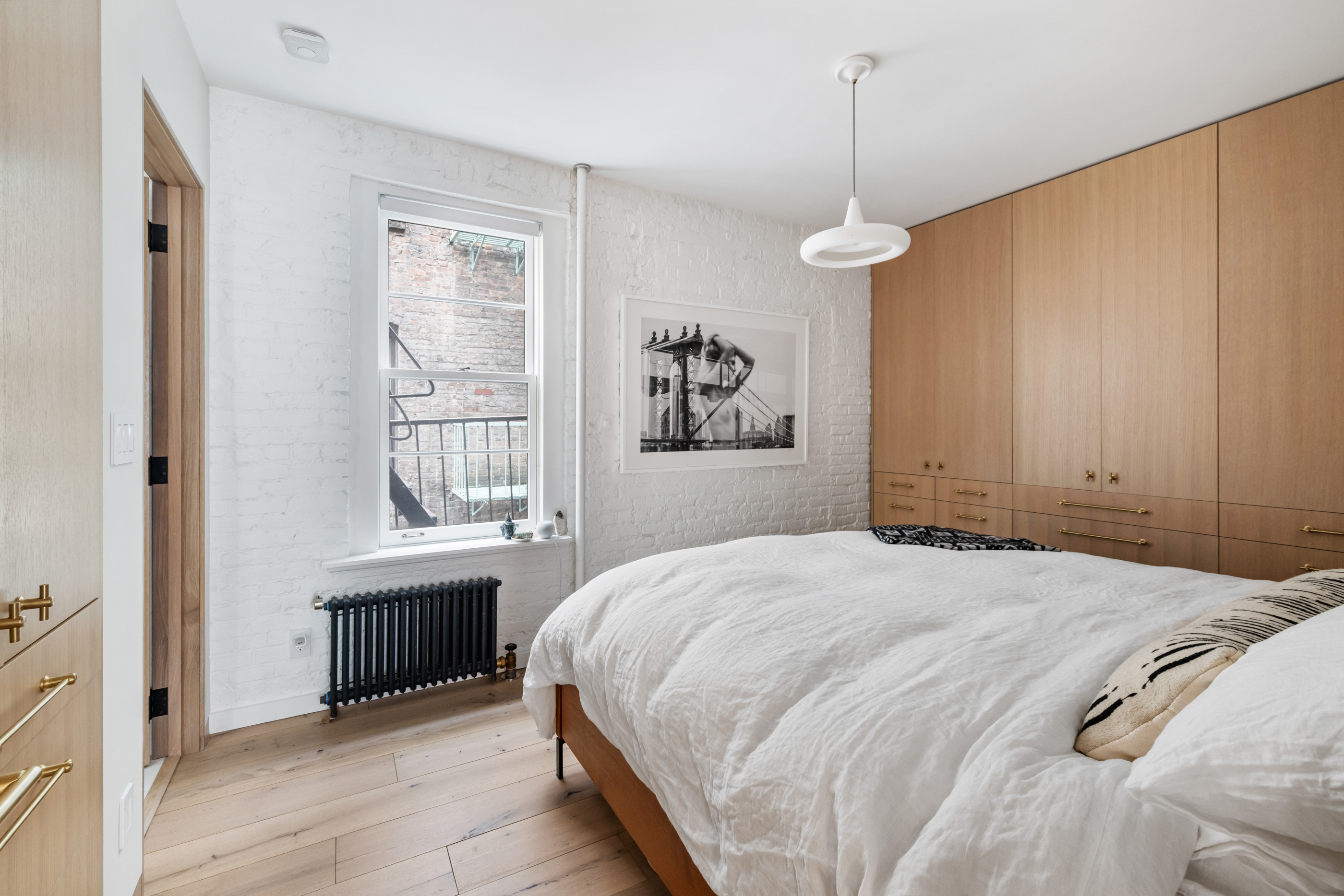 57 Thompson Street, Unit 4E Manhattan, NY 10012 - Photo 12 of 16 a spacious bedroom with a bed and a window