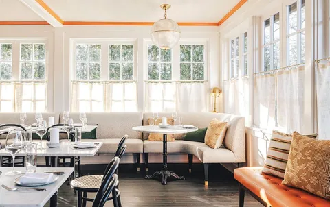 a living room with furniture and large windows