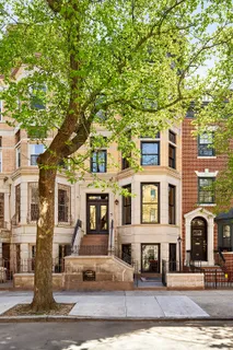 a front view of a residential apartment building with a yard