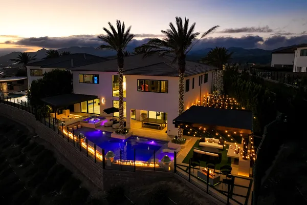 a view of a house with yard fire pit and outdoor seating