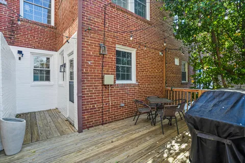 a kitchen with granite countertop a stove a sink and a microwave