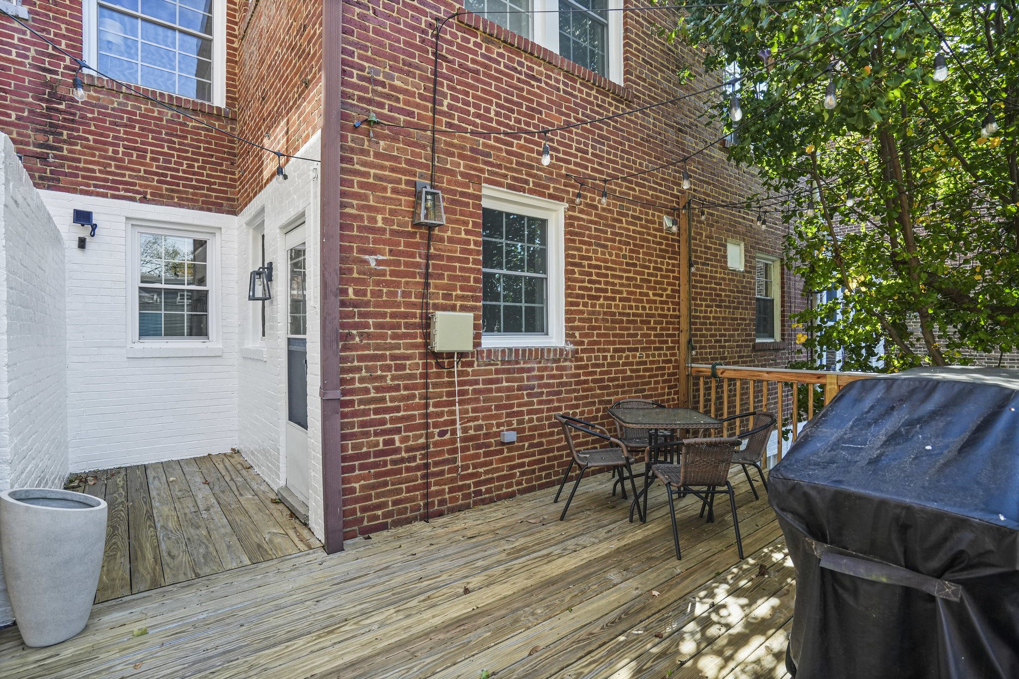 1920 35th Street Northwest Washington, DC 20007 - Photo 31 of 54 a view of a house with wooden deck and furniture