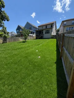 a view of a house with backyard and garden