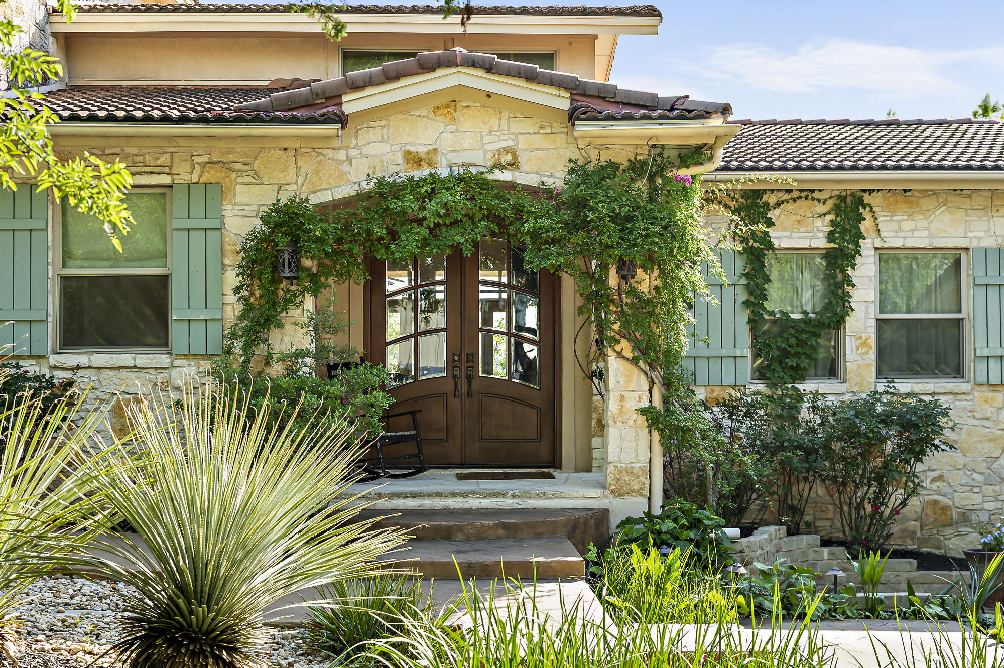 front view of a house with a garden