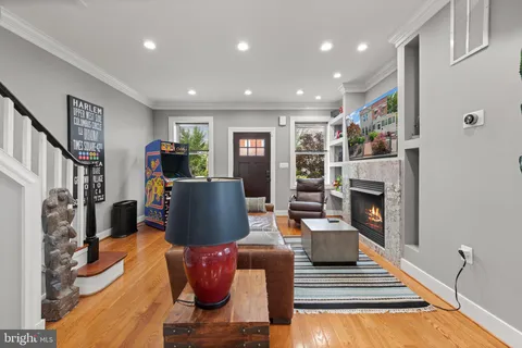 a living room with fireplace furniture and a flat screen tv