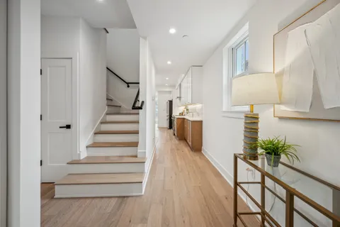 a view of entryway and hall with wooden floor