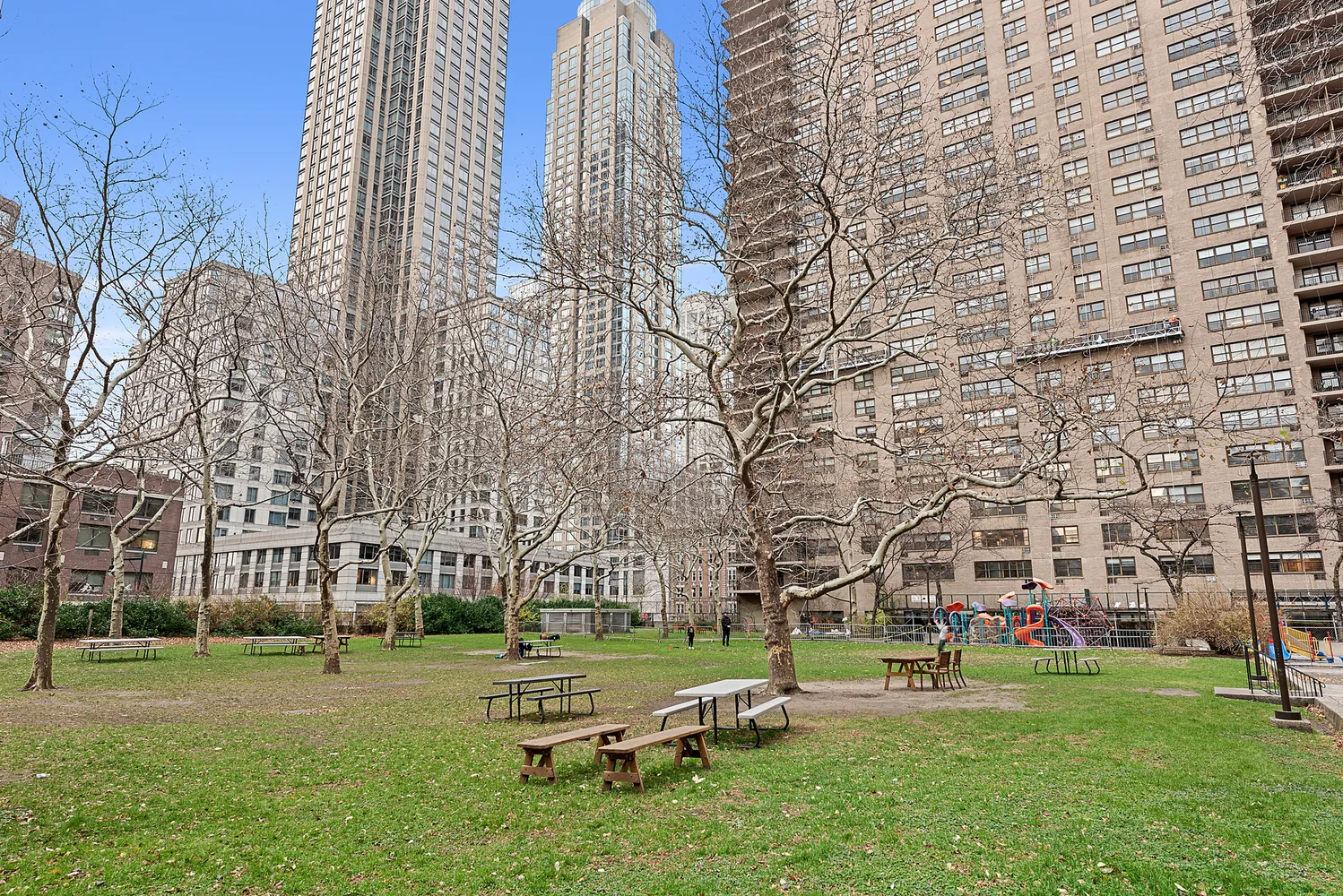 205 West End Avenue, Unit 1E Manhattan, NY 10023 - Photo 13 of 16 a garden with trees and buildings in the background
