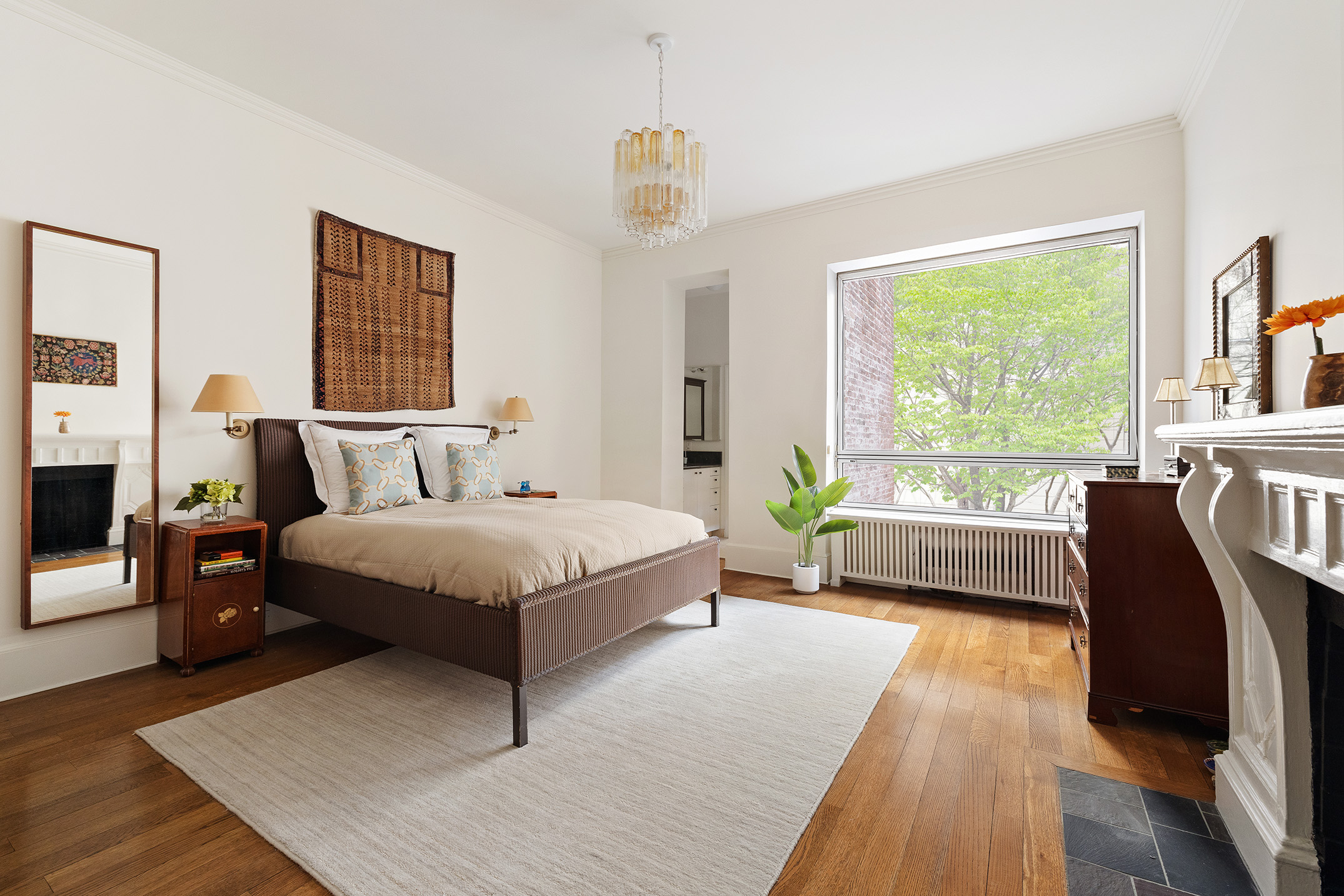 129 East 81st Street Manhattan, NY 10028 - Photo 11 of 17 a bedroom with a bed wooden floor and window