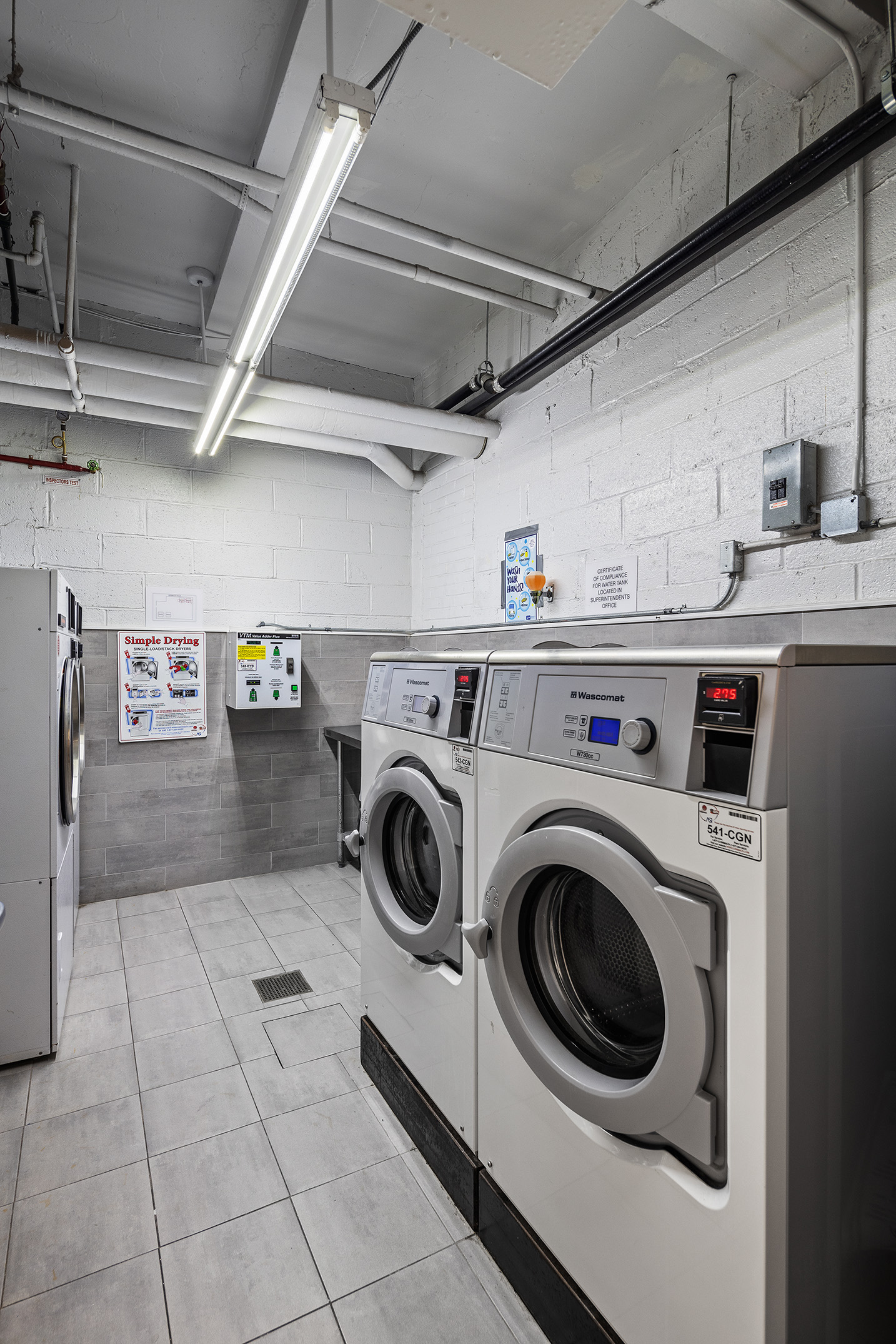 1160 Park Avenue, Unit 8C Manhattan, NY 10128 - Photo 16 of 18 a utility room with dryer and washer