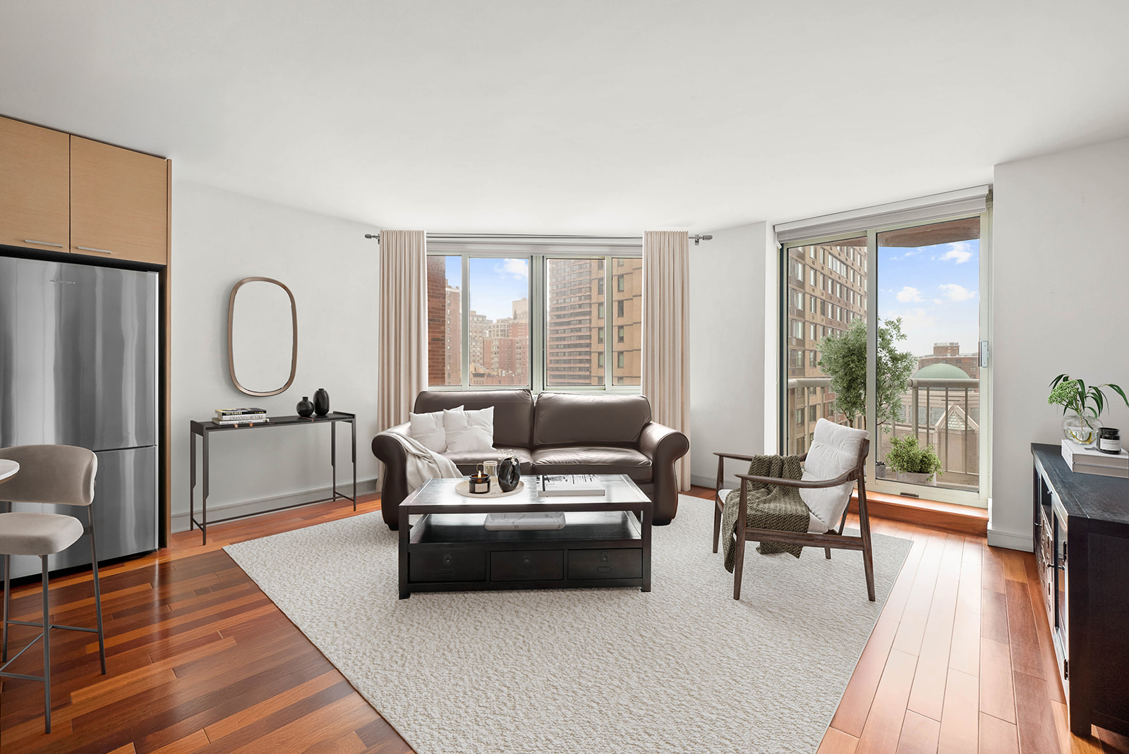 206 East 95th Street, Unit 10B Manhattan, NY 10128 - Photo 2 of 9 a living room with furniture a large window and wooden floor