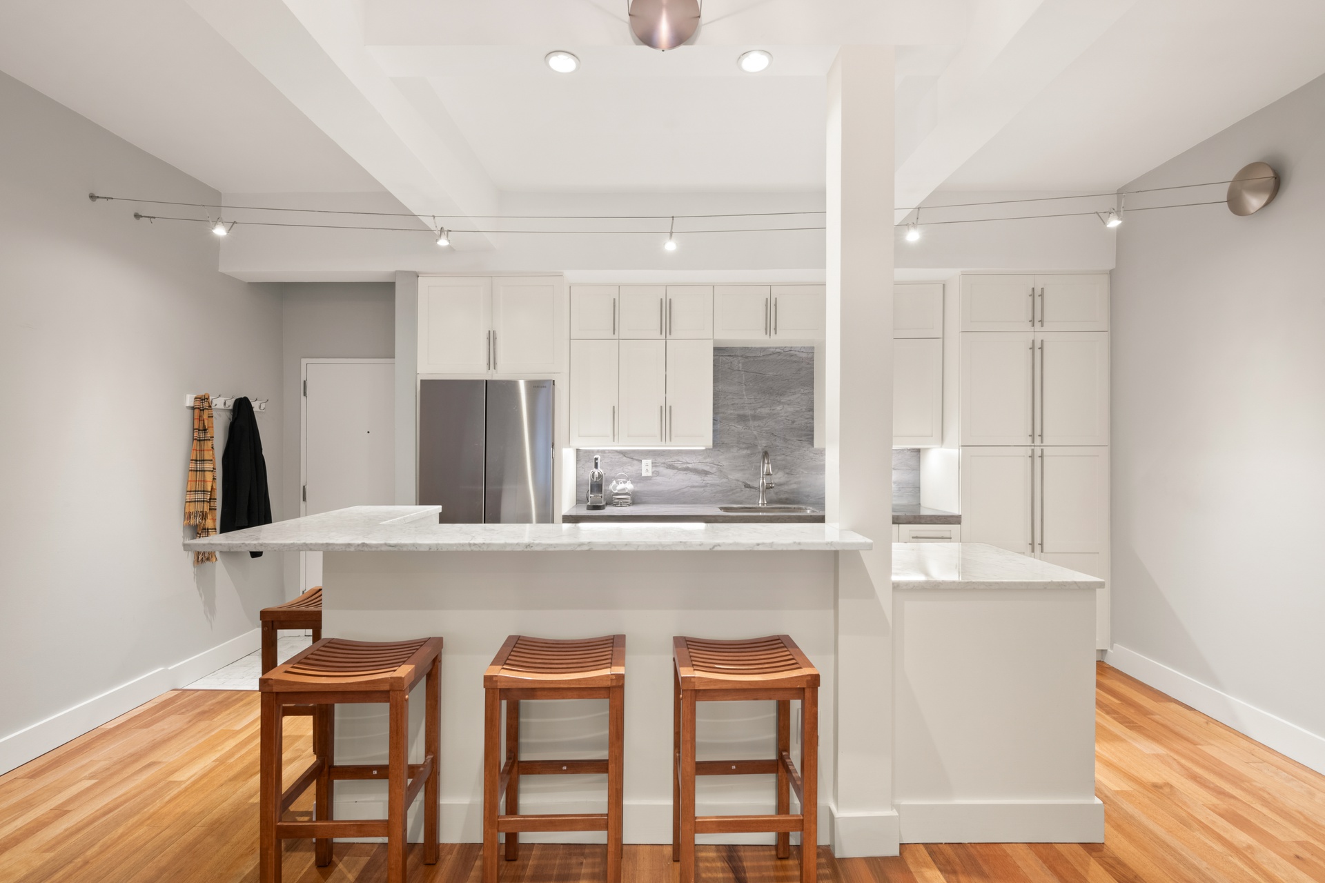 135 West 70th Street, Unit 4A Manhattan, NY 10023 - Photo 3 of 7 a white kitchen with a table and chairs