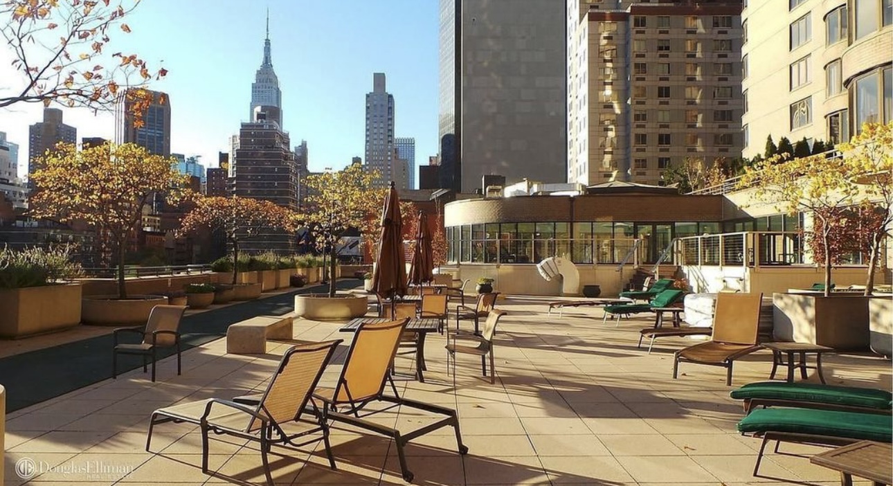 330 East 38th Street, Unit 38I Manhattan, NY 10016 - Photo 13 of 17 a view of a patio with couches and a potted plant on a table