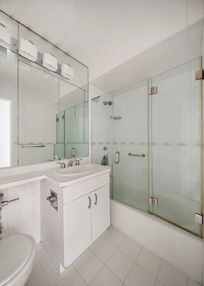 a bathroom with a sink double vanity and a shower