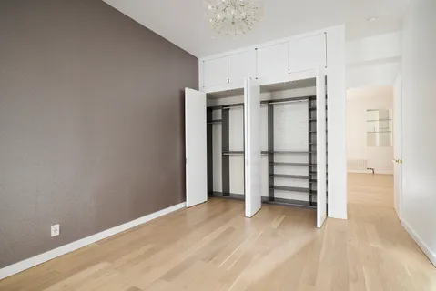 a view of a room with wooden floor and closet