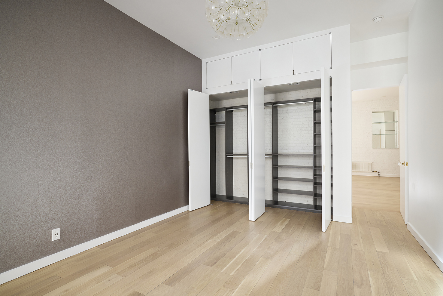 23 East 10th Street, Unit 508 Manhattan, NY 10003 - Photo 15 of 21 a view of a room with wooden floor and closet