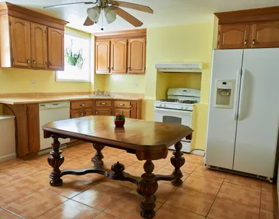 a kitchen with a sink a table and chairs