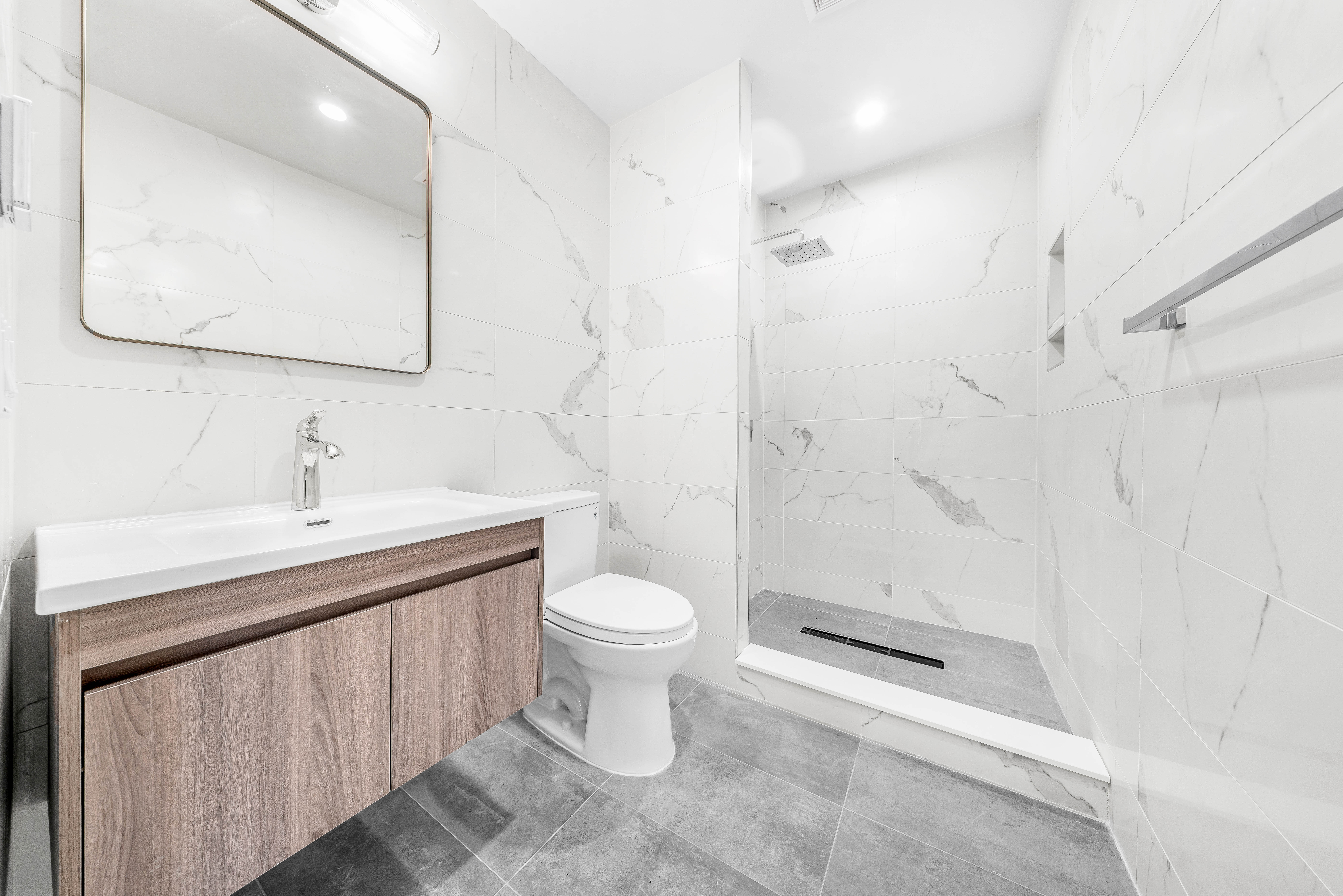 30-24 32nd Street, Unit 4A Queens, NY 11102 - Photo 10 of 22 a bathroom with a sink a toilet and shower