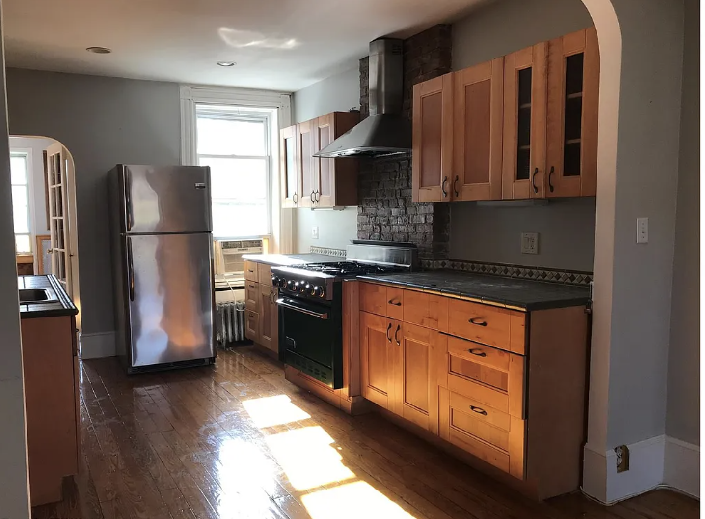 304 7th Avenue, Unit 3 Brooklyn, NY 11215 - Photo 10 of 15 a kitchen with stainless steel appliances granite countertop a refrigerator a sink dishwasher a stove and oven with wooden floor