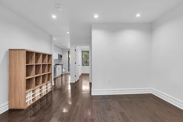 752 Jefferson Avenue, Unit GARDEN Brooklyn, NY 11221 - Photo 2 of 8 a view of wooden floor and windows in a room