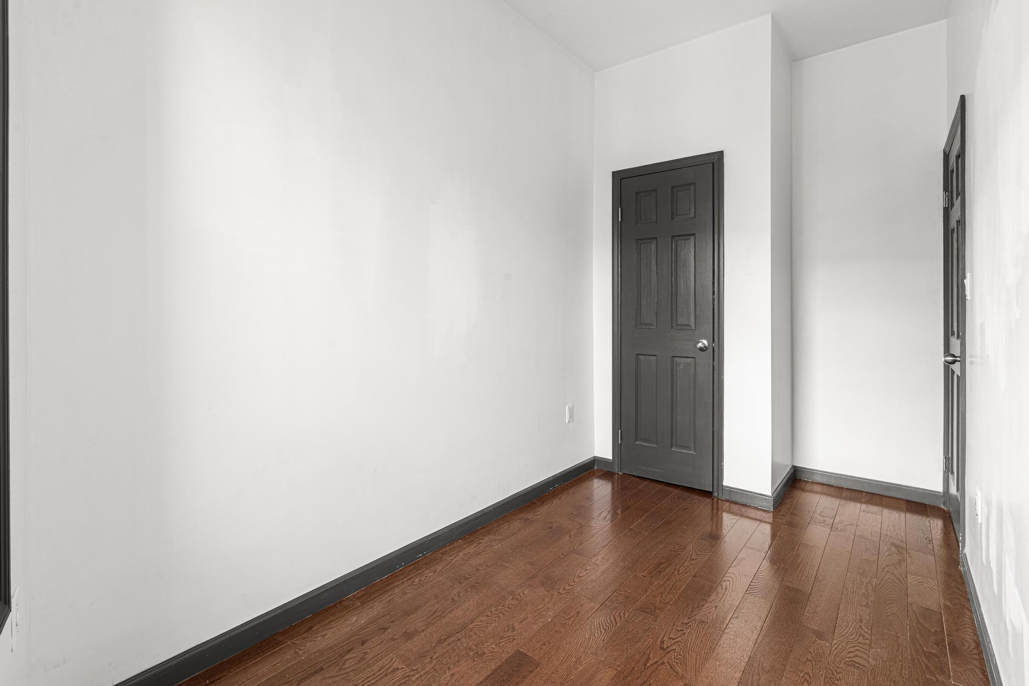 1389 Fulton Street, Unit 3 Brooklyn, NY 11216 - Photo 8 of 12 a view of an empty room with wooden floor and closet