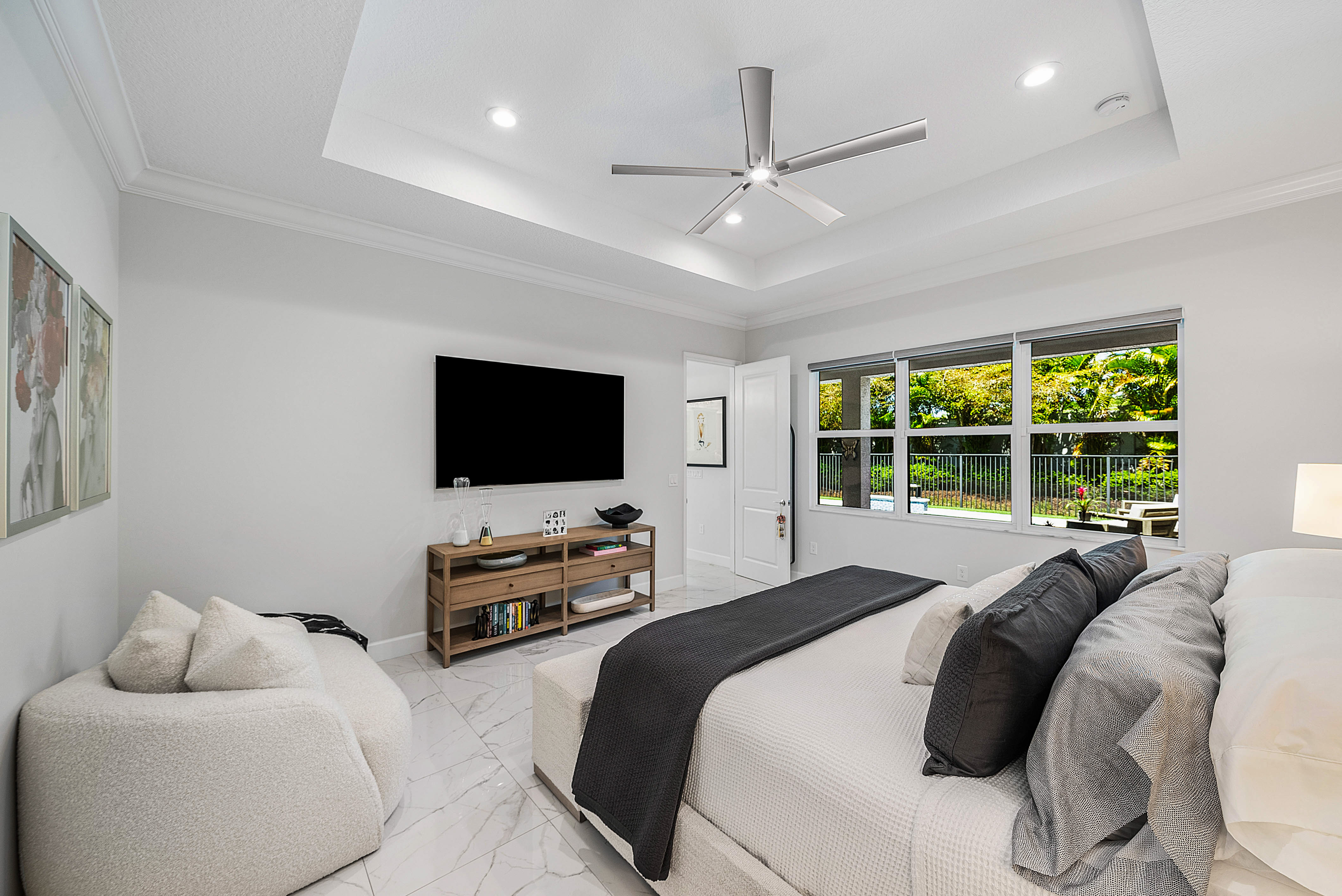 13172 Whistler Mountain Road Delray Beach, FL 33446 - Photo 17 of 38 a bedroom with a bed and a flat screen tv