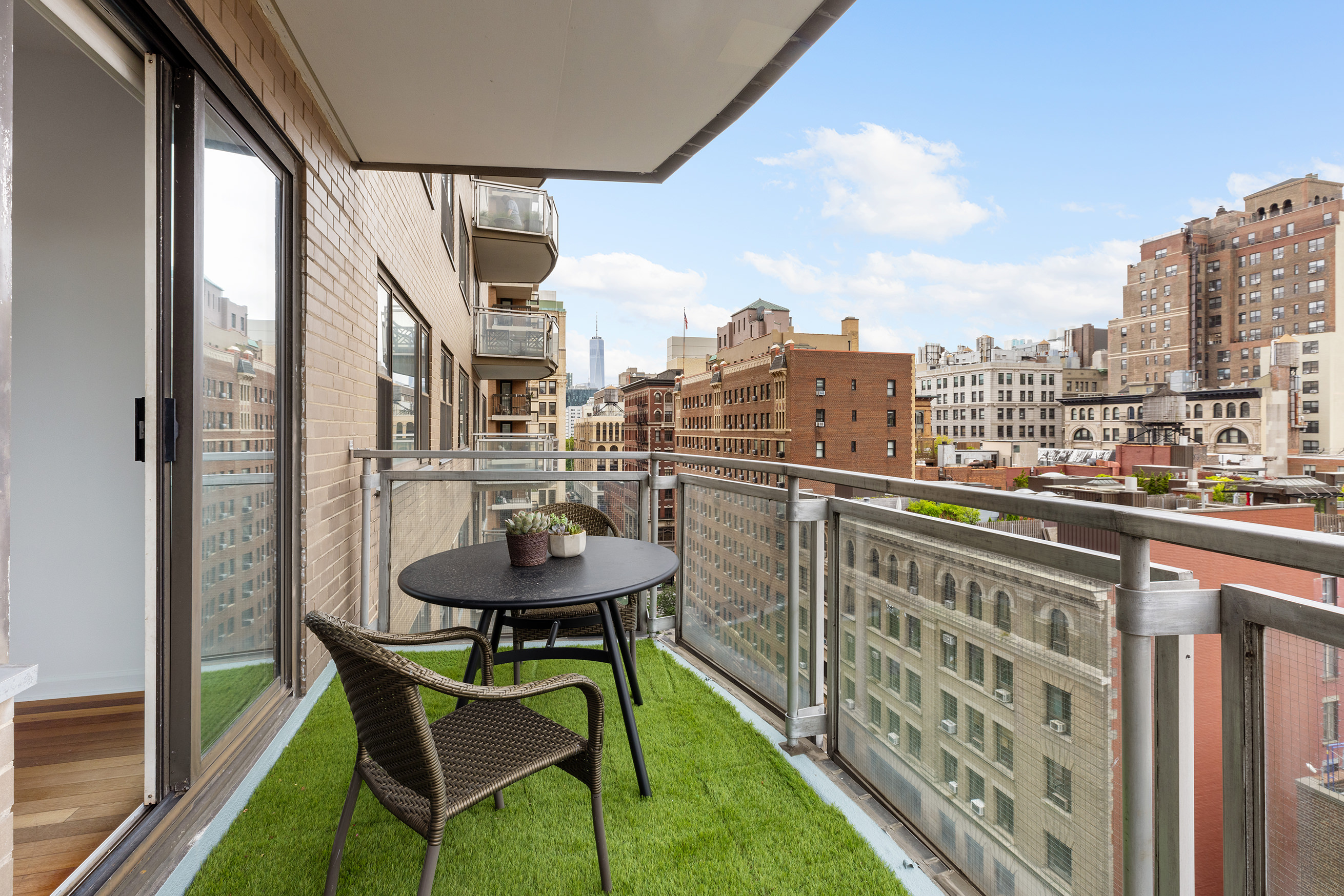60 East 8th Street, Unit 10E Manhattan, NY 10003 - Photo 9 of 13 a balcony with table and chairs