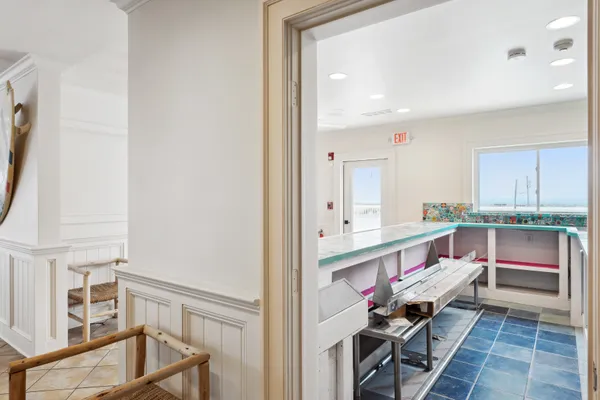 a kitchen with a sink appliances and wooden floor