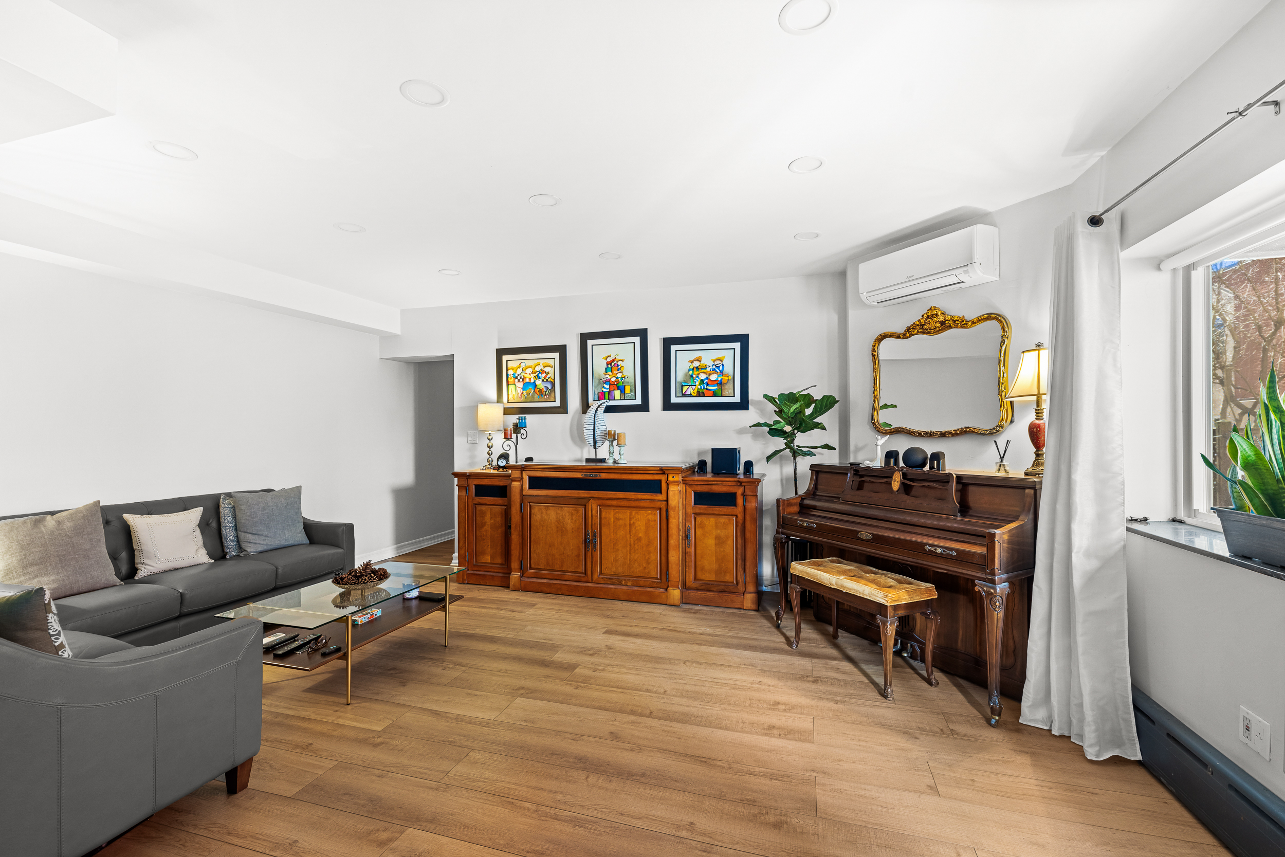 61-20 71st Avenue, Unit J1B Queens, NY 11385 - Photo 4 of 13 a living room with furniture and a piano