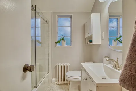 a bathroom with a sink toilet and shower